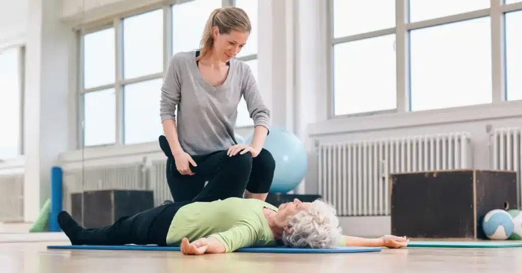 A physical therapist works with a patient. Illustrating the topic, Physical Therapy Awareness Month.