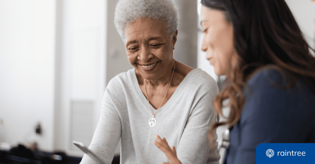 A Patient With Curly Gray Hair And A Healthcare Provider Look Down At A Phone. Illustrating The Topic: &Quot;Patient Experience Week.&Quot;