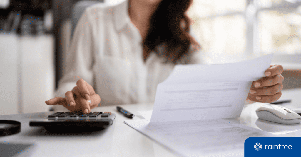 Someone types into a calculator while looking down at a financial document. Illustrating the topic: "Improve Patient Payments with New Ledger Strategies"