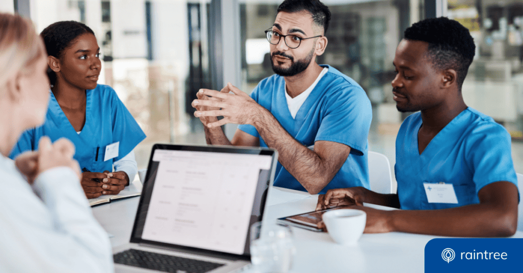 A Group Of Physical Therapists In Blue Scrubs Sit At A Table, Talking Over Coffee. One Of Them Has A Laptop. Illustrating The Topic: &Quot;For Long-Term Pt Practice Growth, You Need Scalable Software.&Quot;