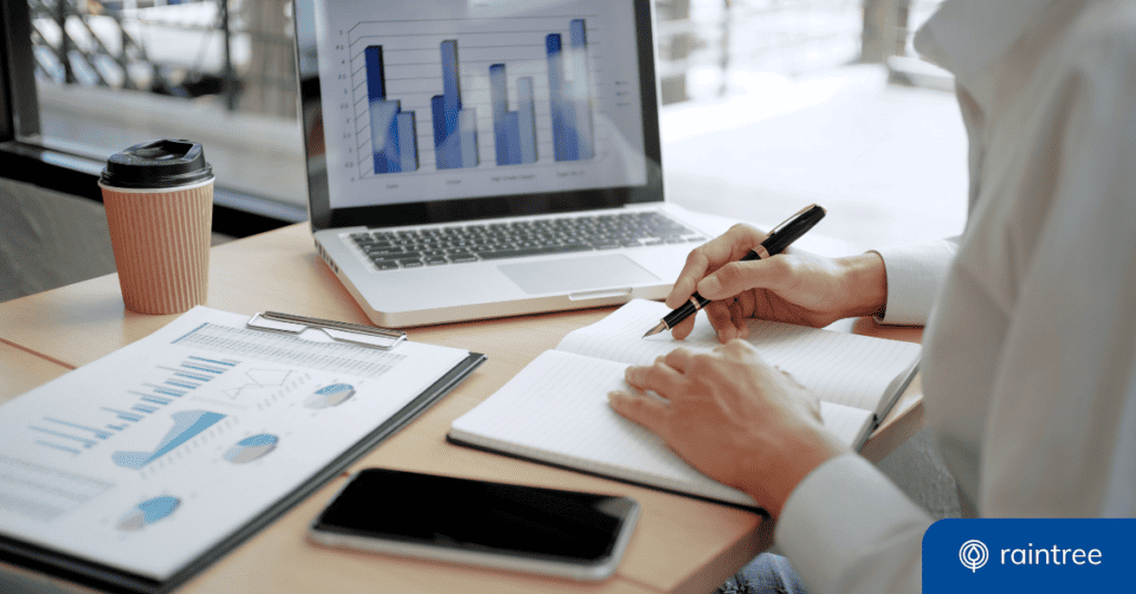Someone sits at a desk looking at a monitor that displays practice insights in a graph. They're holding a pen and ready to write down notes. Illustrating the topic: "How to Use Your Practice Data with Rehabilitation and Physical Therapy Analytics."