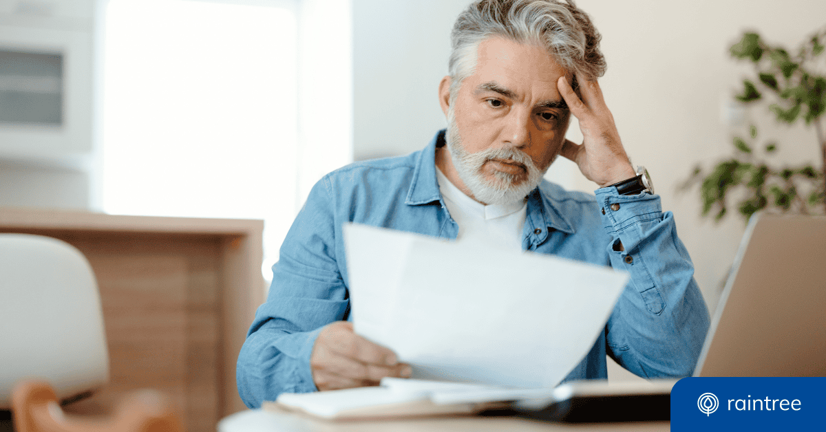 A Patient With Short Gray Hair Reacts With Concern While Looking At A Medical Bill. Illustrating The Importance Of The No Surprises Act.