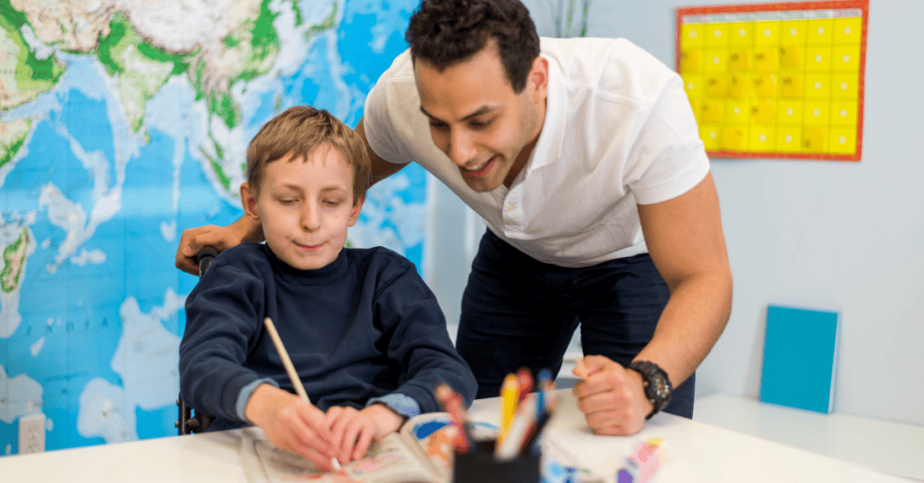 A pediatric occupational therapist works with a young autistic patient, illustrating the topic of autism and OT awareness month.