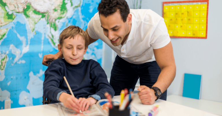 A pediatric occupational therapist works with a young autistic patient, illustrating the topic of autism and OT awareness month.