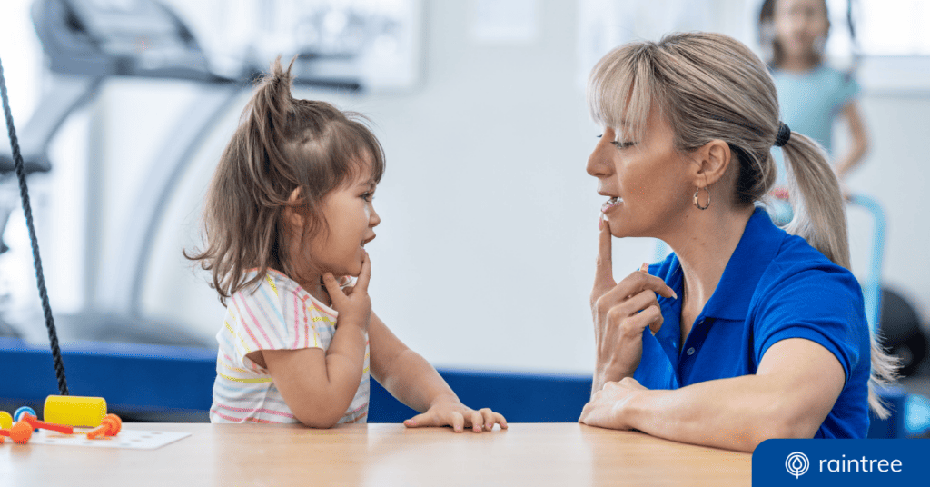 An Slp And A Pediatric Patient Look At One Another While Touching Their Bottom Lips. Illustrating The Topic: Technology In Aba And Speech Therapy.