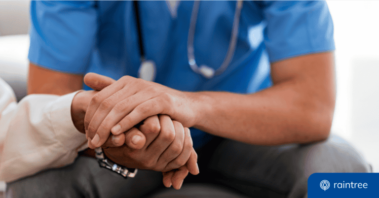 A rehabilitative therapist holds the hand of a senior Medicare patient, illustrating the topic of Medicare cuts for therapy and rehab.
