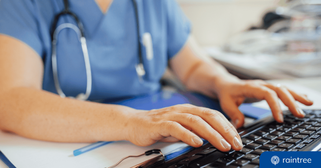Someone wearing scrubs and a stethoscope types on a keyboard, illustrating the lead tracking and electronic referral process.