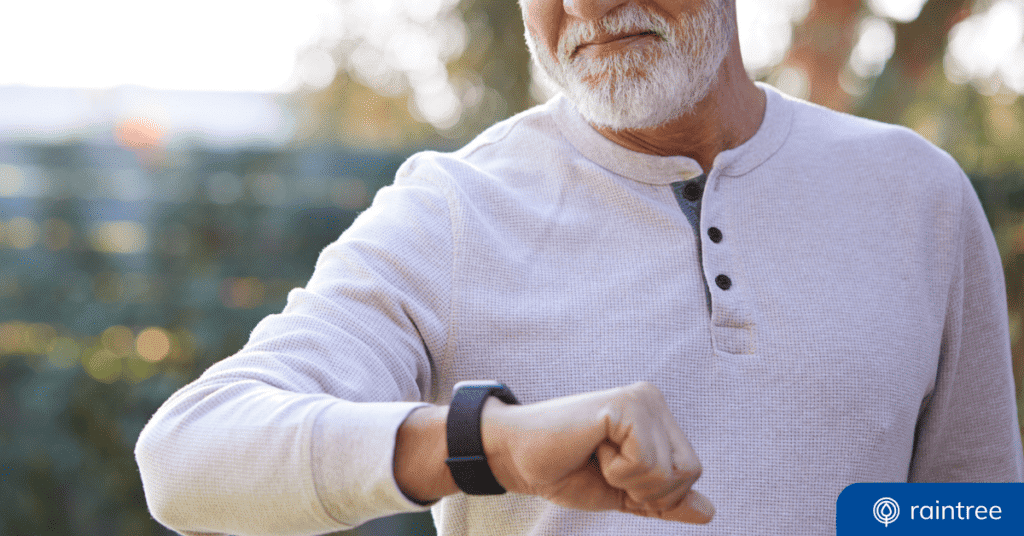 A rehabilitation therapy patient looks down at a smart watch device. Illustrating the topic of "Remote Therapeutic Monitoring."