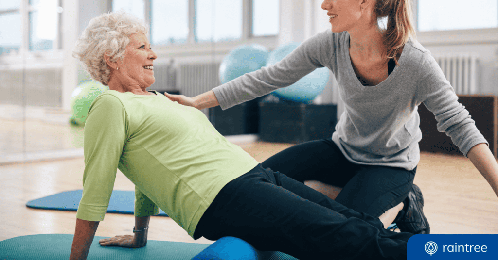 A physical therapist helps a Medicare patient, who leans back while looking up and smiling. Illustrating the topic: "A new MIPS Value Pathway for rehabilitation therapy."