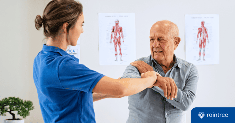 A physical therapist works with a patient, who holds his arm and frowns in pain. Illustrating the topic, "How to Face the Physical Therapy Workforce Shortage in the U.S."