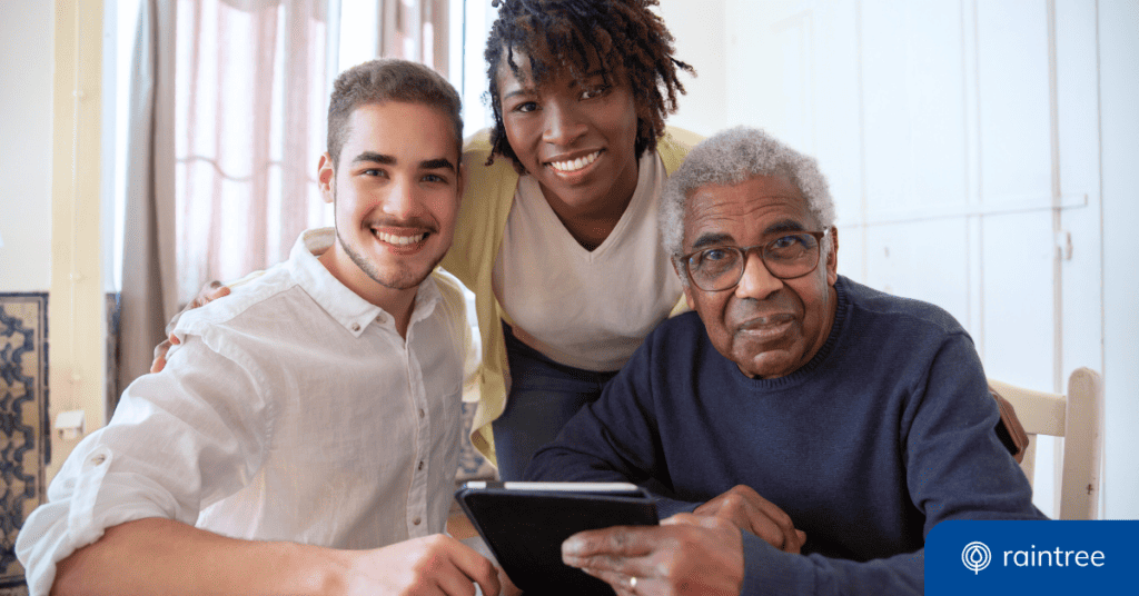 Three People Pose For A Picture, Looking At The Camera. The Group Includes Two Younger Adults, Perhaps Caregivers Or Physical Therapists, And One Older Patient Who Holds A Tablet Device. Illustrating The Topic: &Quot;Generational Trends In Patient Engagement For Rehabilitation Therapy Practices.&Quot;