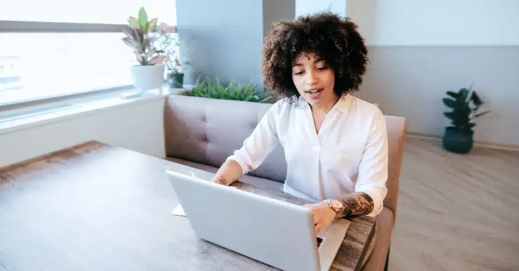 A Person Sitting At A Table And Using A Computer. Illustrating The Topic: &Quot;Pediatric Therapy Staffing Challenges.&Quot;