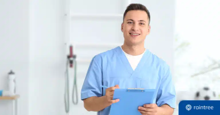 A Rehabilitation Specialist Holds A Clipboard While Standing Inside A Clinic With Exercise Equipment In The Background. Illustrating The Topic Of Provider Recredentialing.