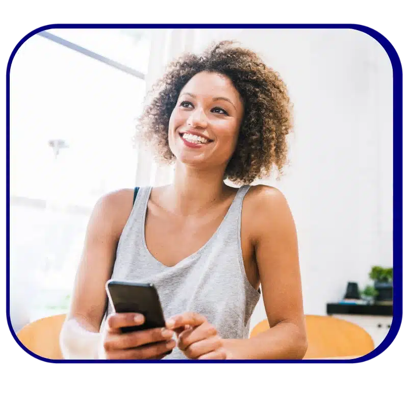 News 1 Raintree News Hero: A Physical Therapy Professional Wearing A Gray Tank Top Smiles, Holding Her Phone.