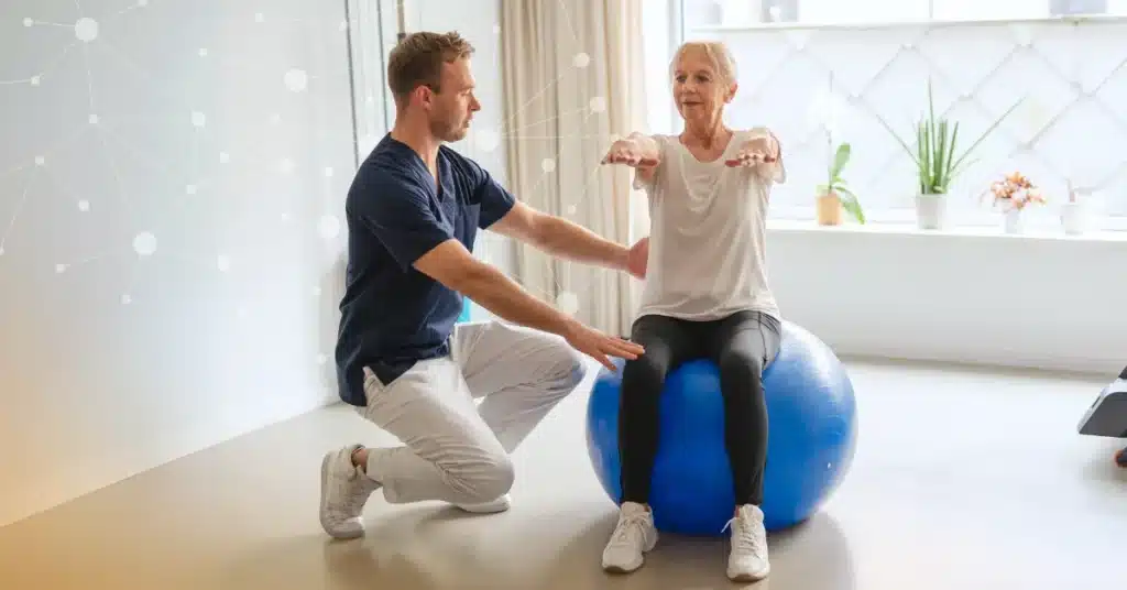 A physical therapist works with a patient who sits on a balance ball with her arms extended, and a neural grid in the background illustrating the topic of AI in physical therapy.