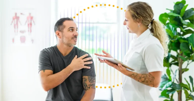 A Physical Therapist Holding A Tablet Makes Eye Contact With A Pt Patient Who Touches His Shoulder; Behind Them Is A Sound Wave, Illustrating The Benefits Of Ambient Ai In The Rehabilitation Therapy Setting.