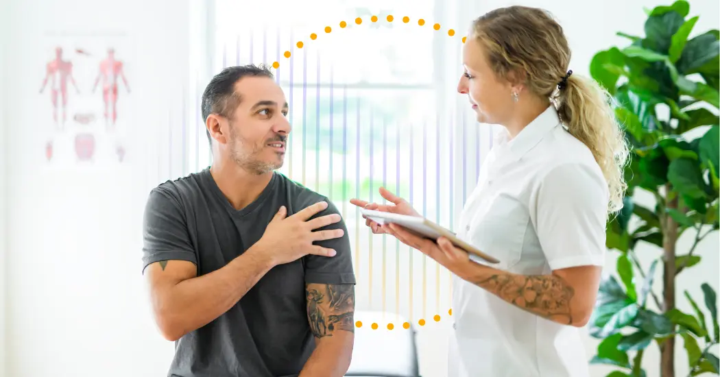 A Physical Therapist Holding A Tablet Makes Eye Contact With A Pt Patient Who Touches His Shoulder; Behind Them Is A Sound Wave, Illustrating The Benefits Of Ambient Ai In The Rehabilitation Therapy Setting.