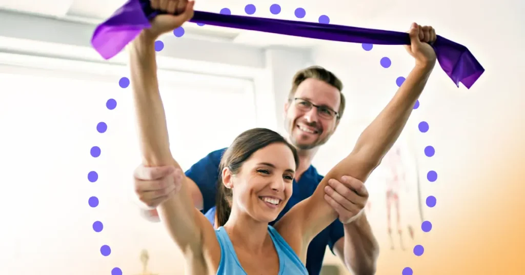 A male physical therapist supports a female patient who holds a band above her head, smiling. Illustrating the topic of Raintree's product evolution strategy.