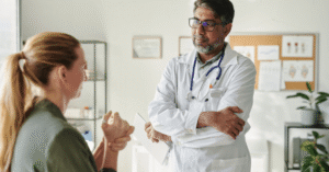 Physician meeting with a patient who has a hand injury. Illustrating the topic: Interoperability in rehab therapy.