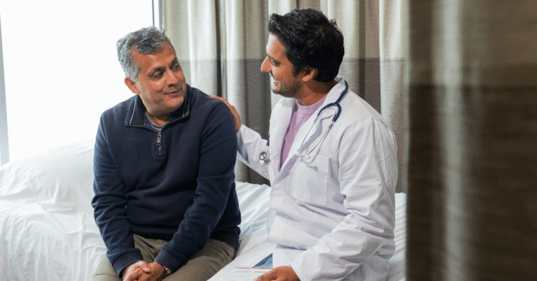 Raintree Pathways™ | Referral Management For Rehab Therapy 15 A Physician Smiles And Touches The Shoulder Of A Surgical Patient, Illustrating The Topic Of Referral Management In Rehab Therapy.